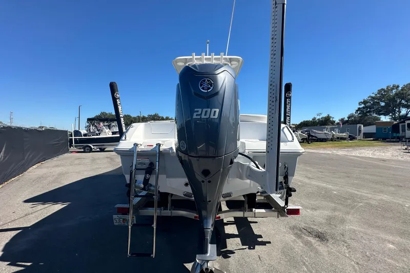 Slide: The Image of 2024 Sea Hunt Ultra 219 boat with Yamaha 200 engine, parked outdoors. - 99
