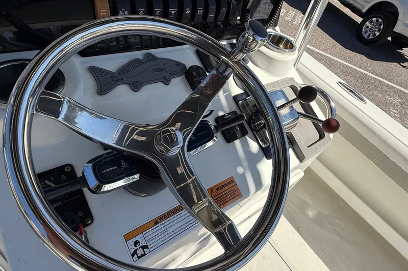 Slide: The Image of Steering wheel and controls of 2022 Parker 2100 Special Edition boat. - 11
