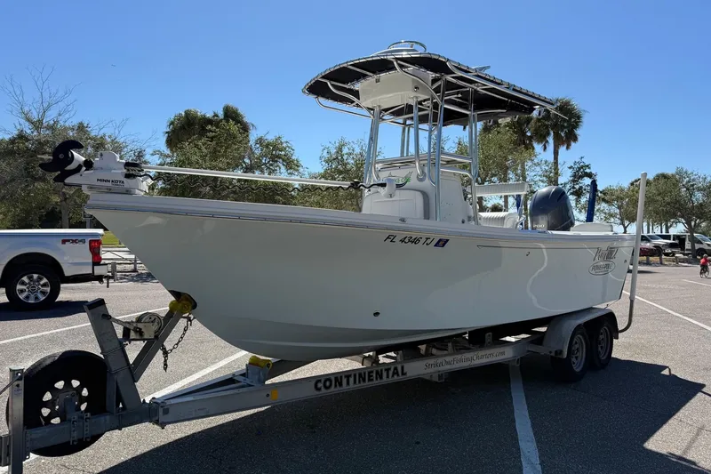 Slide: The Image of 2022 Parker 2100 Special Edition boat on trailer in sunny parking lot. - 2