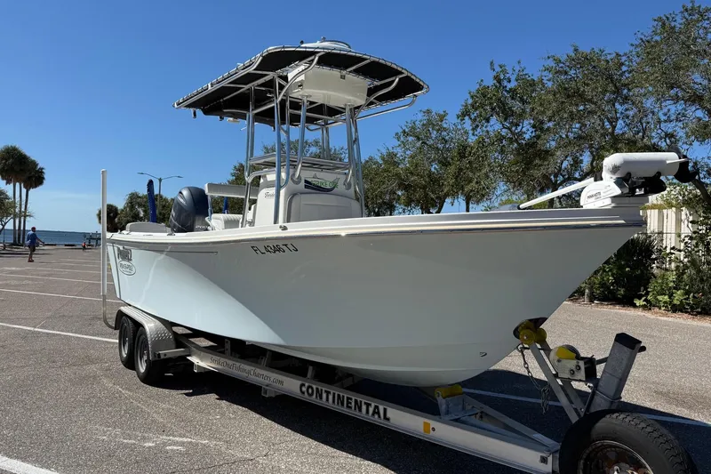 Slide: The Image of 2022 Parker 2100 Special Edition boat on trailer, parked outdoors under clear sky. - 3
