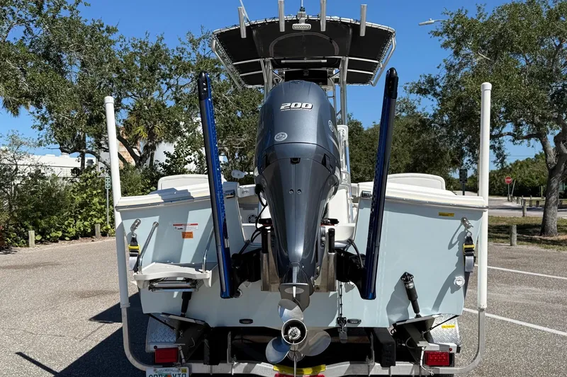 Slide: The Image of 2022 Parker 2100 Special Edition boat with 200 HP engine, parked outdoors. - 5