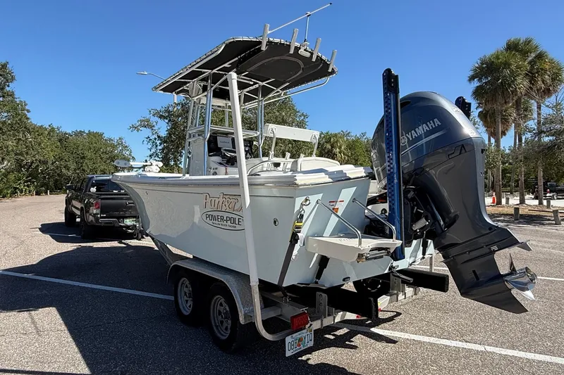 Slide: The Image of 2022 Parker 2100 Special Edition boat on trailer with Yamaha engine, parked outdoors. - 6
