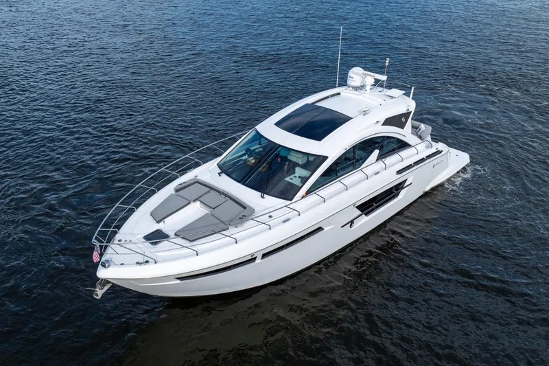 Slide: The Image of 2022 Cruisers Yachts 54 Cantius luxury boat cruising on open water. - 10