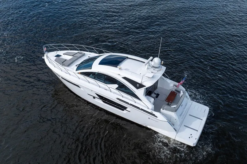 Slide: The Image of 2022 Cruisers Yachts 54 Cantius luxury boat cruising on open water. - 11