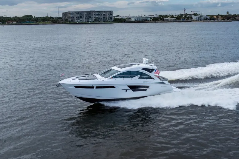 Slide: The Image of 2022 Cruisers Yachts 54 Cantius luxury yacht cruising on open water. - 2