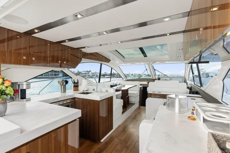 Slide: The Image of Luxurious interior of 2022 Cruisers Yachts 54 Cantius with modern kitchen and panoramic windows. - 24