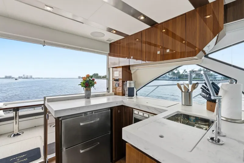 Slide: The Image of Luxurious 2022 Cruisers Yachts 54 Cantius kitchen with modern design and scenic water view. - 26