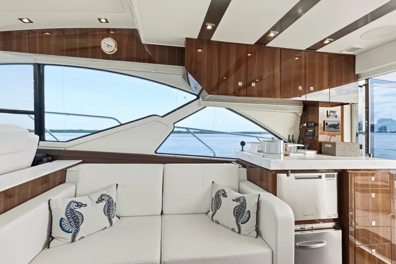 Slide: The Image of Luxurious interior of 2022 Cruisers Yachts 54 Cantius with modern kitchen and elegant seating. - 27