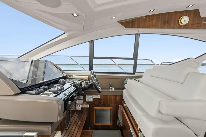 Slide: The Image of 2022 Cruisers Yachts 54 Cantius helm with luxurious seating and modern controls. - 28