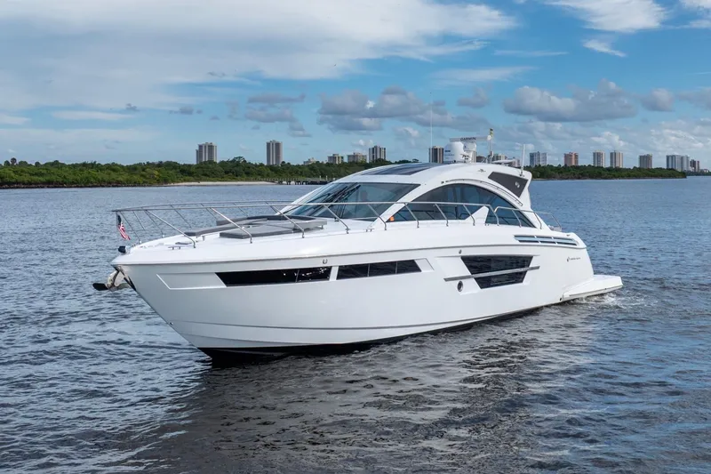 Slide: The Image of 2022 Cruisers Yachts 54 Cantius luxury yacht cruising on open water. - 3