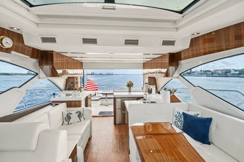 Slide: The Image of Luxurious interior of 2022 Cruisers Yachts 54 Cantius with elegant seating and scenic ocean view. - 31