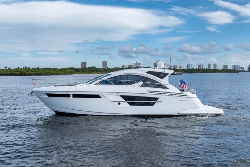 Slide: The Image of 2022 Cruisers Yachts 54 Cantius luxury yacht cruising on a scenic waterway. - 4