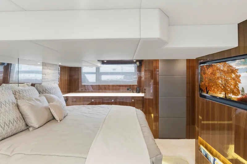 Slide: The Image of Luxurious bedroom interior of 2022 Cruisers Yachts 54 Cantius with elegant decor and TV. - 44