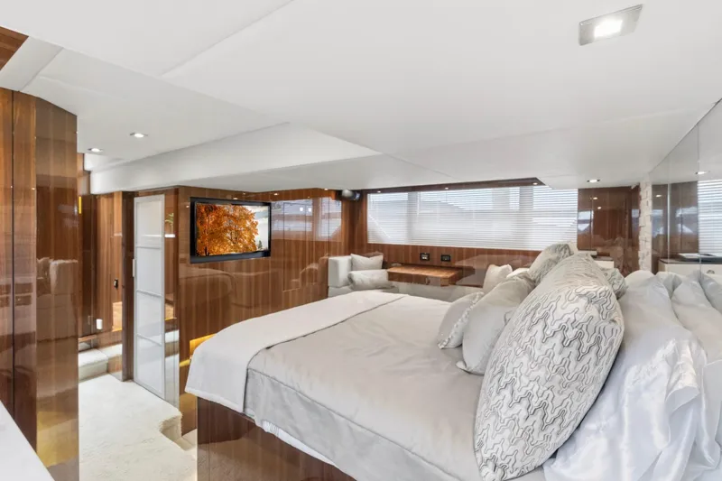 Slide: The Image of Luxurious 2022 Cruisers Yachts 54 Cantius bedroom with elegant wood paneling and modern decor. - 46