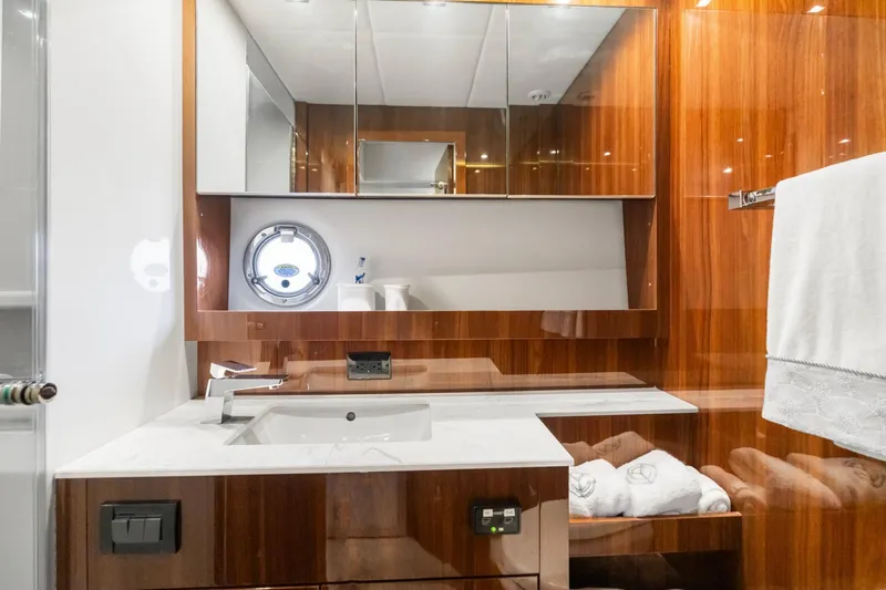 Slide: The Image of Luxurious bathroom in 2022 Cruisers Yachts 54 Cantius with elegant wood finish and modern fixtures. - 49