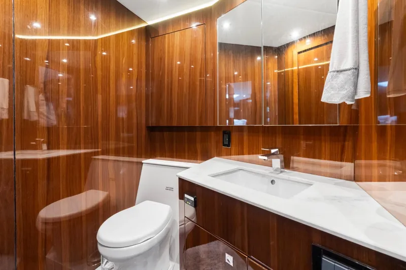 Slide: The Image of Luxurious bathroom in 2022 Cruisers Yachts 54 Cantius, featuring wood paneling and modern fixtures. - 60