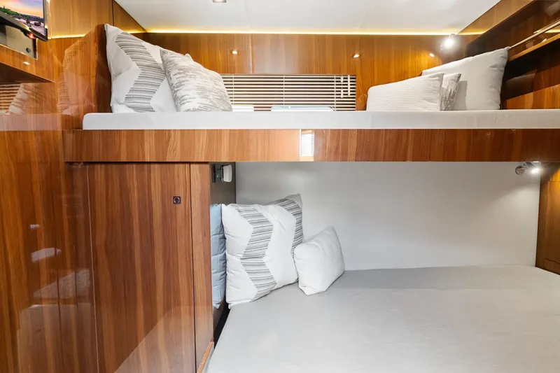 Slide: The Image of 2022 Cruisers Yachts 54 Cantius interior with luxurious wooden bunk beds and modern lighting. - 65