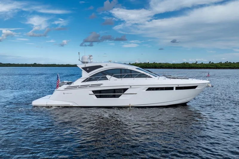 Slide: The Image of 2022 Cruisers Yachts 54 Cantius luxury boat cruising on open water. - 7