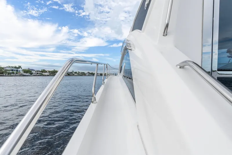 Slide: The Image of 2022 Cruisers Yachts 54 Cantius side view with ocean and sky background. - 17