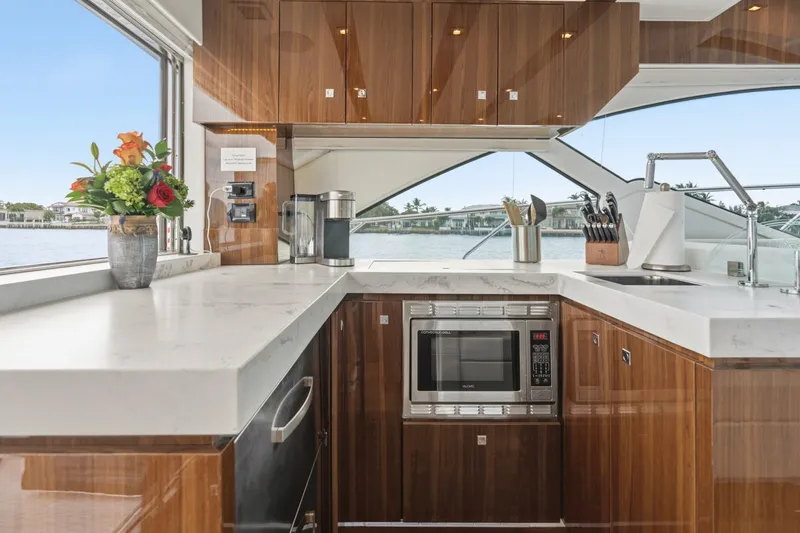 Slide: The Image of Luxurious kitchen interior of 2022 Cruisers Yachts 54 Cantius with modern appliances and waterfront view. - 25