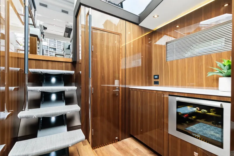 Slide: The Image of Luxurious interior of 2022 Cruisers Yachts 54 Cantius with modern wood finish and wine cooler. - 37