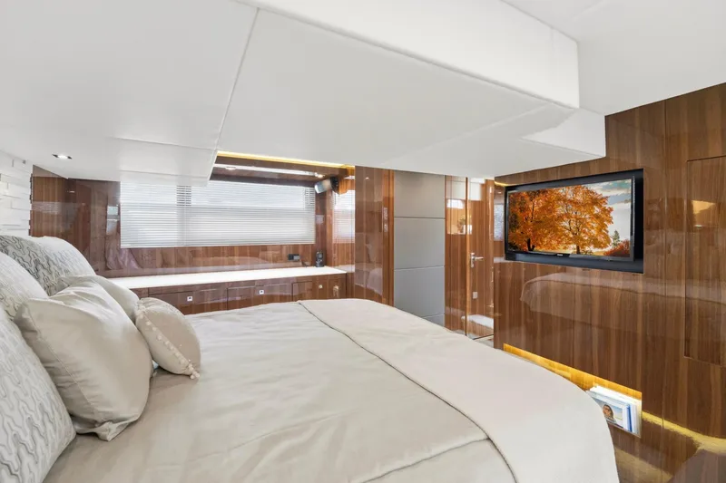 Slide: The Image of Luxurious bedroom interior of 2022 Cruisers Yachts 54 Cantius with wood paneling and TV. - 43