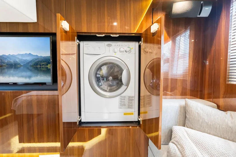 Slide: The Image of 2022 Cruisers Yachts 54 Cantius interior with built-in washer and TV. - 48