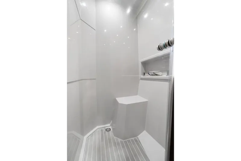 Slide: The Image of Modern shower interior in 2022 Cruisers Yachts 54 Cantius, featuring sleek design and built-in seat. - 54