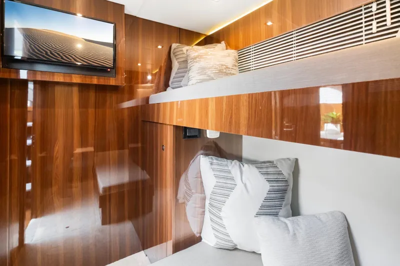 Slide: The Image of Luxurious interior of 2022 Cruisers Yachts 54 Cantius with wood paneling and cozy bedding. - 66