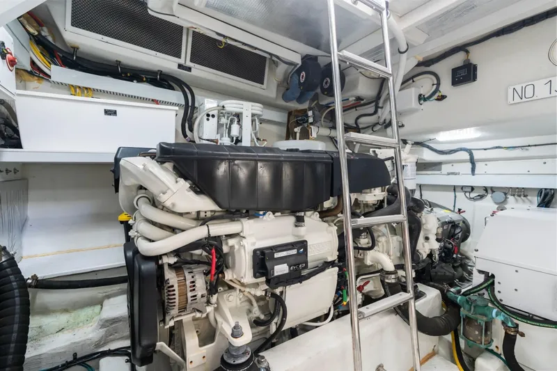 Slide: The Image of Engine room of 2022 Cruisers Yachts 54 Cantius with visible machinery and ladder. - 69