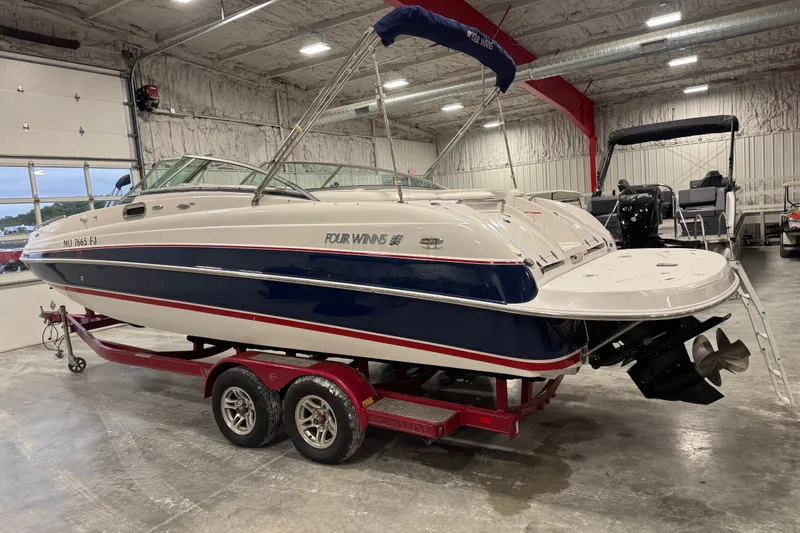 Slide: The Image of 2006 Four Winns 244 Funship boat on red trailer in indoor storage facility. - 3