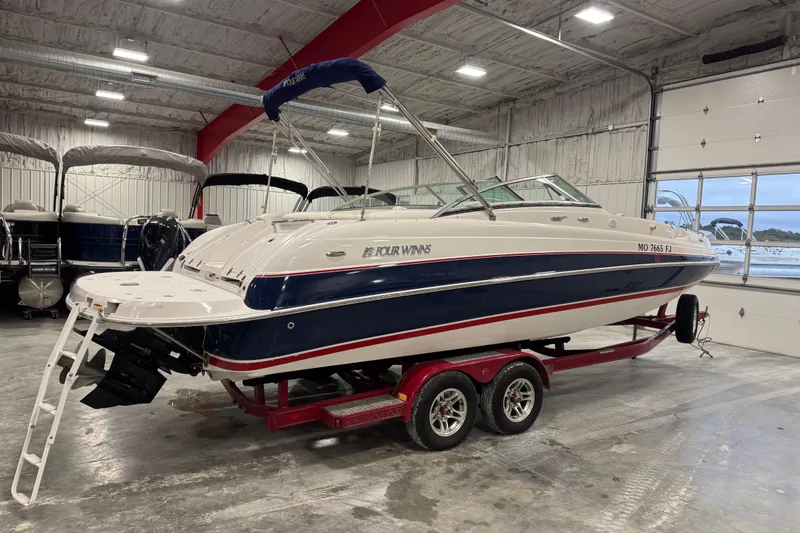 Slide: The Image of 2006 Four Winns 244 Funship boat on trailer in indoor storage facility. - 4