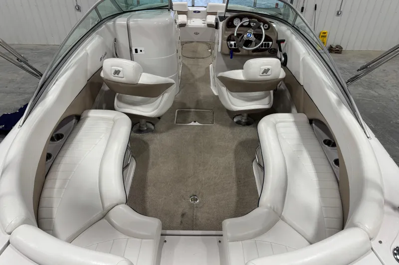 Slide: The Image of 2006 Four Winns 244 Funship boat interior with white seating and steering console. - 6