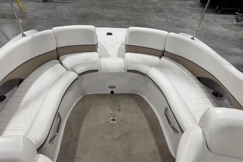 Slide: The Image of 2006 Four Winns 244 Funship boat interior with white seating and carpeted floor. - 7
