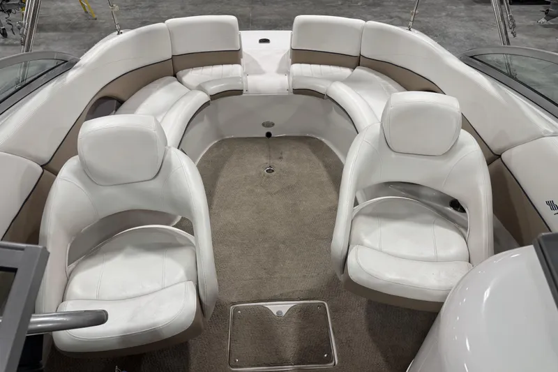 Slide: The Image of Interior of a 2006 Four Winns 244 Funship boat with white seating and carpeted floor. - 8