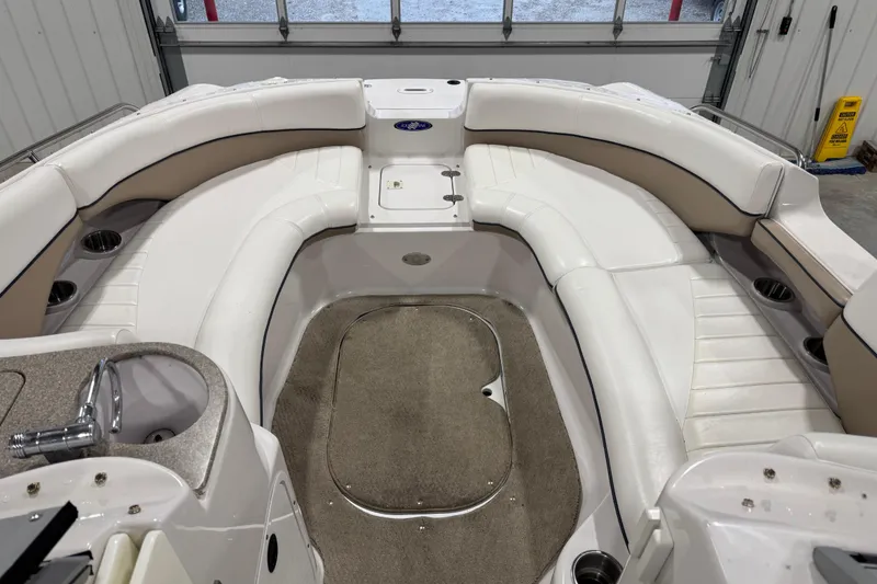 Slide: The Image of 2006 Four Winns 244 Funship boat interior with white seating and carpeted floor. - 9