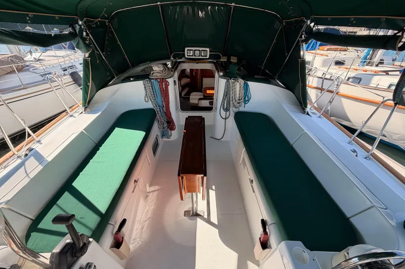 Slide: The Image of Cockpit of 2003 Beneteau Oceanis Clipper 473 sailboat with green seating and canopy. - 12