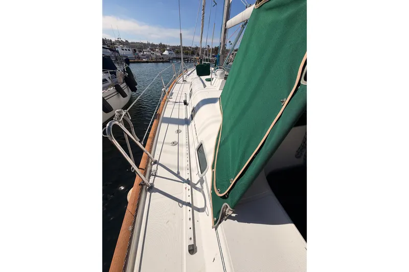 Slide: The Image of 2003 Beneteau Oceanis Clipper 473 sailboat deck with green cover, docked in marina. - 13