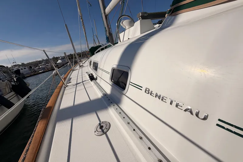 Slide: The Image of 2003 Beneteau Oceanis Clipper 473 sailboat docked, showcasing sleek design and branding. - 14