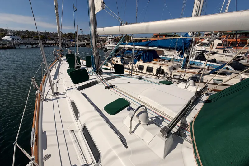 Slide: The Image of 2003 Beneteau Oceanis Clipper 473 sailboat docked in marina, showcasing deck and rigging. - 15