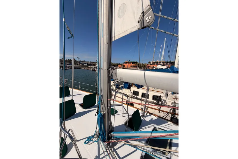 Slide: The Image of 2003 Beneteau Oceanis Clipper 473 sailboat docked in a sunny marina. - 16