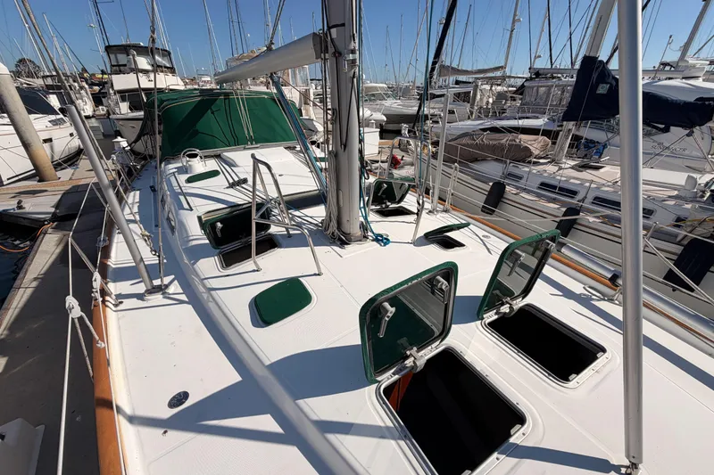 Slide: The Image of 2003 Beneteau Oceanis Clipper 473 sailboat docked, open hatches, marina background. - 25