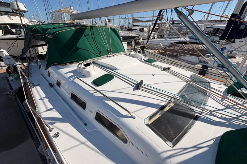 Slide: The Image of 2003 Beneteau Oceanis Clipper 473 sailboat with green canopy, docked in a marina. - 26
