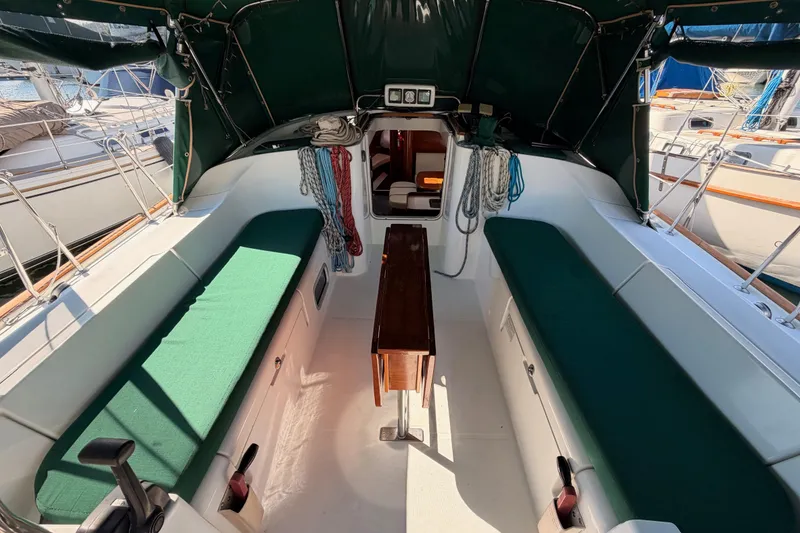 Slide: The Image of Interior view of 2003 Beneteau Oceanis Clipper 473 sailboat with green seating and wooden table. - 29