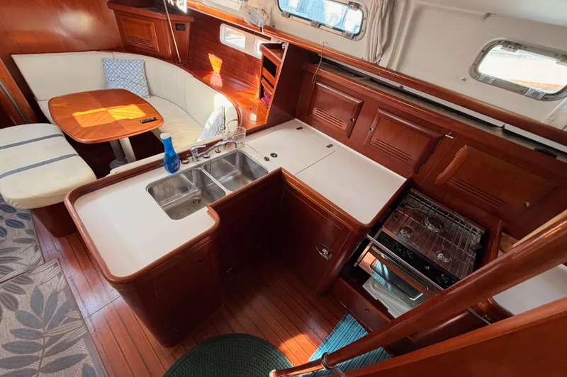 Slide: The Image of Interior of 2003 Beneteau Oceanis Clipper 473 yacht with kitchen and dining area. - 32