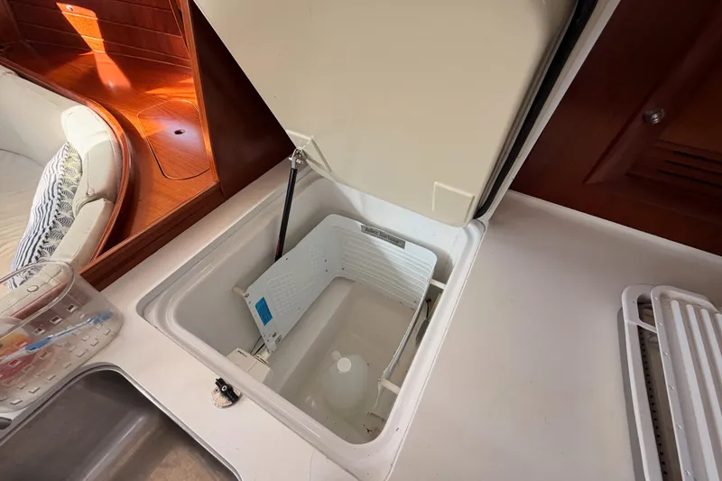 Slide: The Image of 2003 Beneteau Oceanis Clipper 473 yacht interior with open storage compartment. - 36