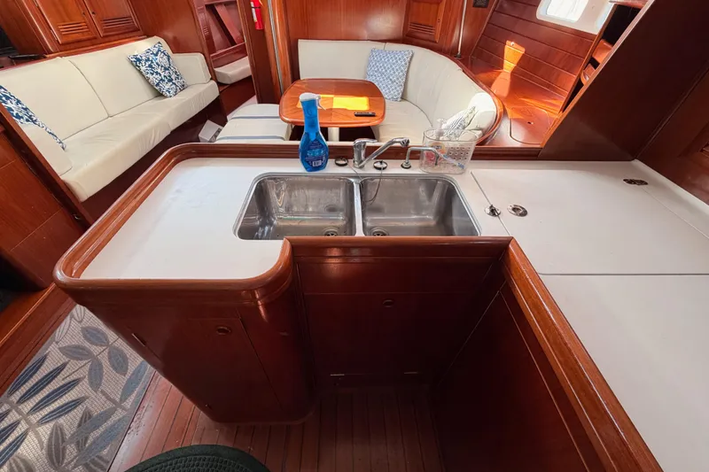 Slide: The Image of Interior of 2003 Beneteau Oceanis Clipper 473 yacht with kitchen and seating area. - 38