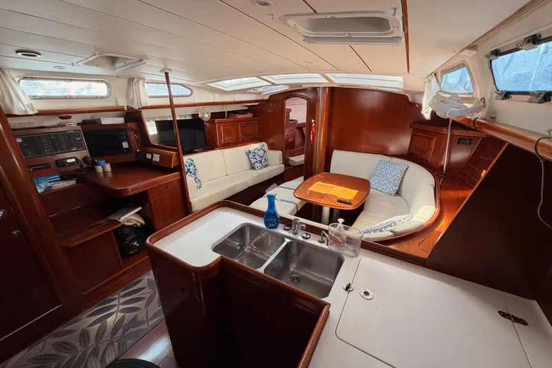 Slide: The Image of Interior of 2003 Beneteau Oceanis Clipper 473 yacht with elegant wood finish and seating area. - 39