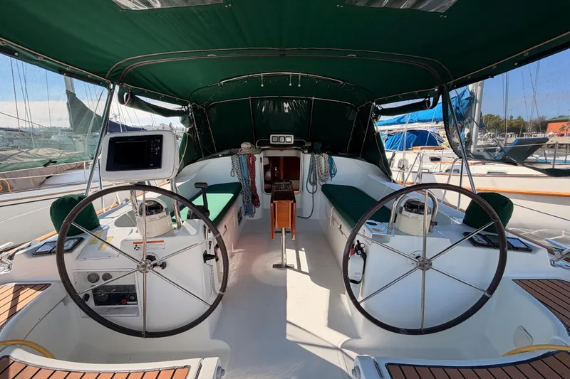 Slide: The Image of Interior view of 2003 Beneteau Oceanis Clipper 473 sailboat cockpit with dual steering wheels. - 4