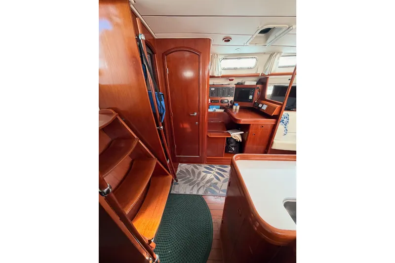 Slide: The Image of Interior of 2003 Beneteau Oceanis Clipper 473 yacht with wooden cabinetry and navigation station. - 40